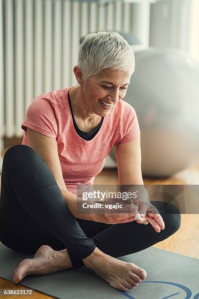 mature woman doing blood sugar test after exercise. - diabetes stockfoto's en -beelden