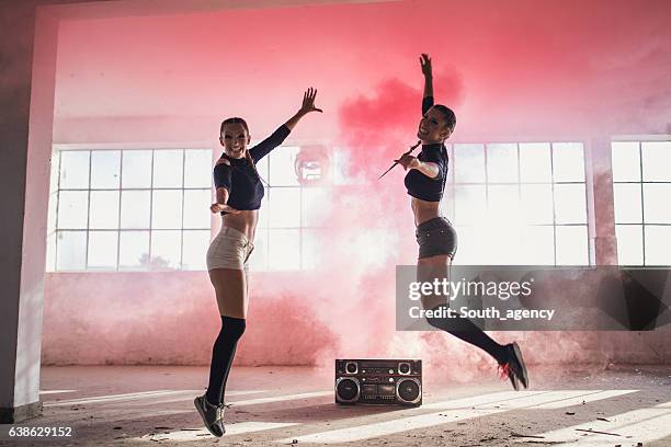 girls in pink smoke - warehouse jump work in joy stock pictures, royalty-free photos & images