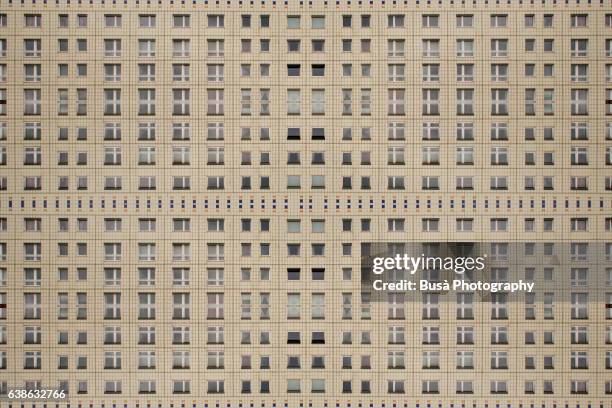 impossible architectures: digital manipulation of rows of windows of an unrenovated plattanbau building in berlin mitte, close to alexanderplatz - plattenbau stock-fotos und bilder