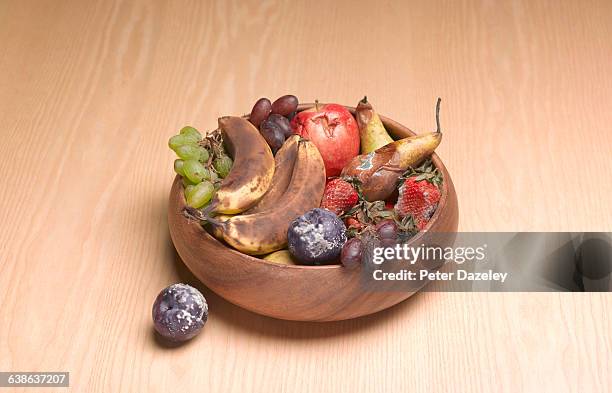 bowl of rotting fruit on table - fruit decay stockfoto's en -beelden