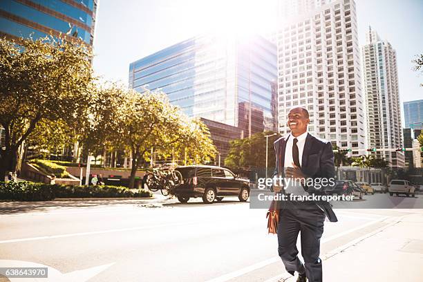 afro american businessman running in miami downtown - miami business imagens e fotografias de stock