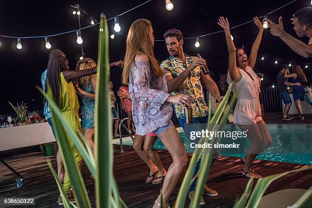 friends enjoying pool party - pool party night stock pictures, royalty-free photos & images