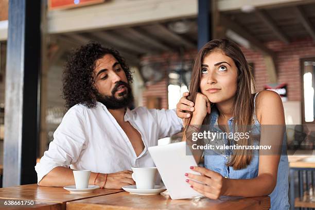 young couple drinking coffee in cafe - bored girlfriend stock pictures, royalty-free photos & images