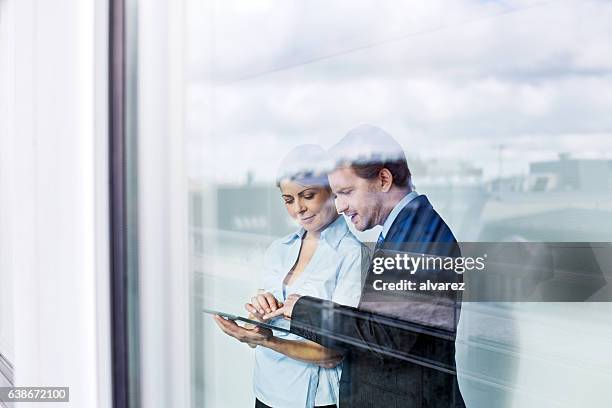 business people in office using digital tablet - achterdeur stockfoto's en -beelden