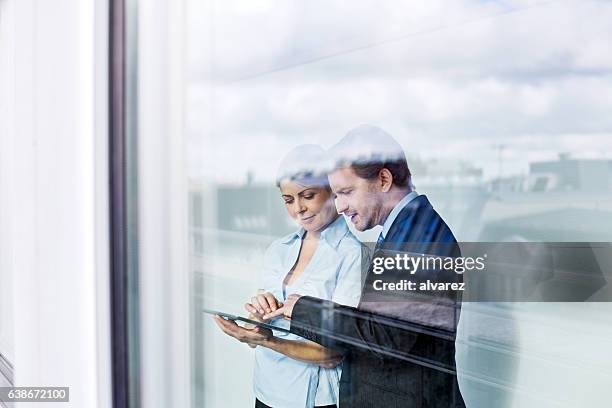 business people in office using digital tablet - glass business man stock pictures, royalty-free photos & images