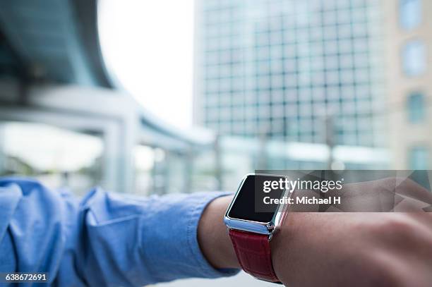 businessman using smartwatch. - arm span stockfoto's en -beelden