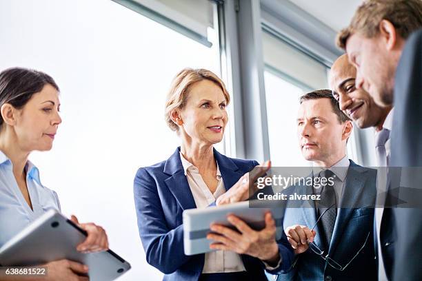 businesswoman explaining new business ideas to colleagues - knowledge sharing business stock pictures, royalty-free photos & images