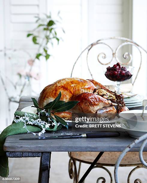 roast chestnut turkey on patio christmas table - christmas table turkey stock pictures, royalty-free photos & images