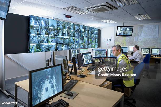 security guards in security control room with video wall - security equipment stock pictures, royalty-free photos & images