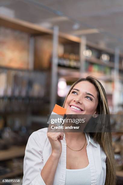 business owner holding a business card - loyalty program stock pictures, royalty-free photos & images