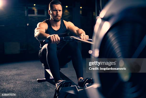 rowing machine exercising - rowing machine stock pictures, royalty-free photos & images