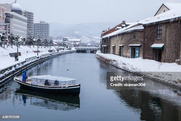 view of grand canal of otaru village small city and landmark snow cover city - hokkaido city stock pictures, royalty-free photos & images