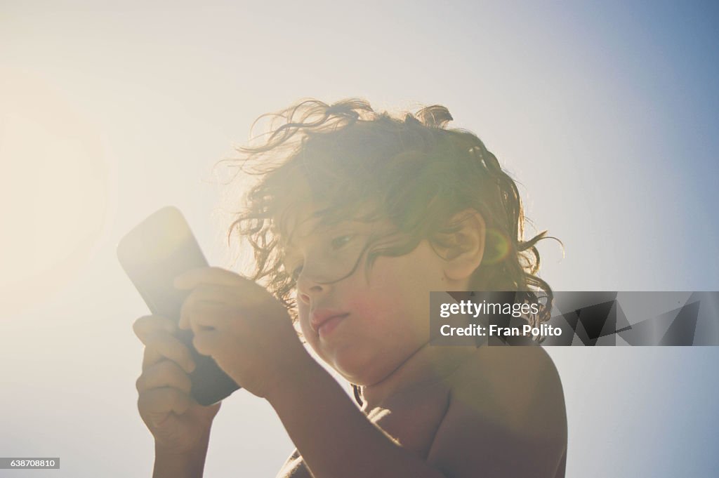 Boy looking at smart phone.