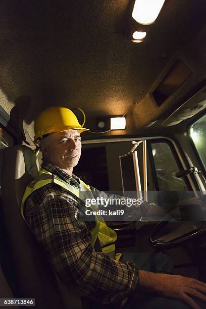 mature man driving truck - construction vehicle stock pictures, royalty-free photos & images