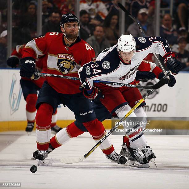 Jakub Kindl of the Florida Panthers tangles with Josh Anderson Columbus Blue Jackets at the BB&T Center on January 14, 2017 in Sunrise, Florida.