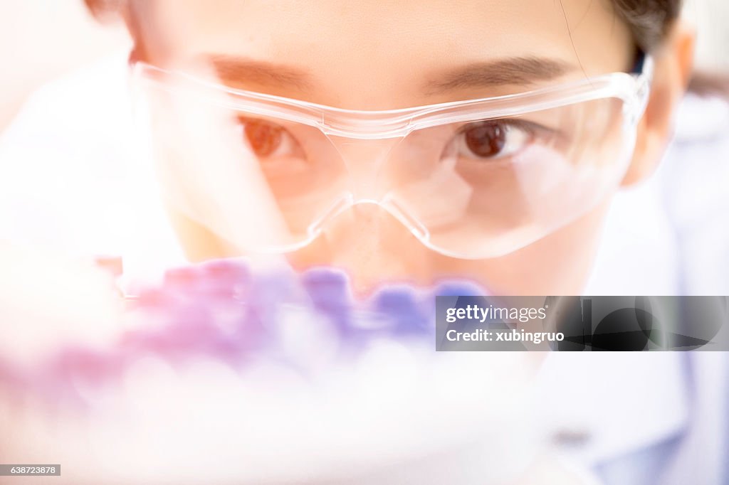 Female chemist at work in laboratory.