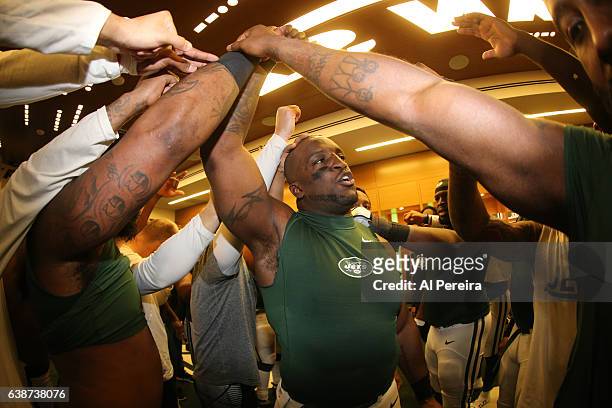 Linebacker David Harris of the New York Jets addresses the team in the locker room after the game against the Buffalo Bills at MetLife Stadium on...
