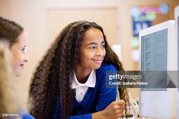 cute girls learning computer programming - african american school uniform stock pictures, royalty-free photos & images