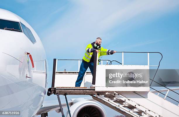 airport worker on the aircraft stairs - ground crew stock pictures, royalty-free photos & images