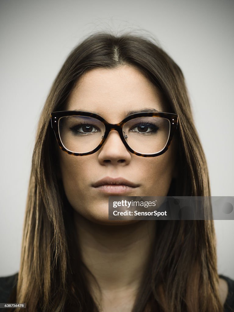 Close-up portrait of confident young woman