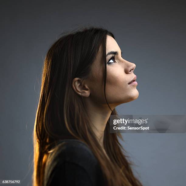 beautiful woman posing against dark background - brown hair model stock pictures, royalty-free photos & images