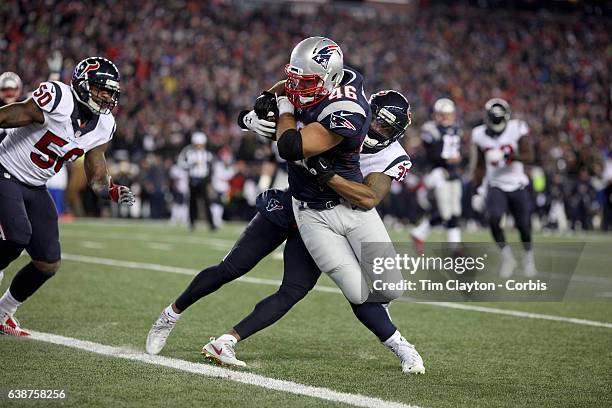 Fullback James Develin of the New England Patriots is tackled short of the line by defensive back Eddie Pleasant of the Houston Texans during the...