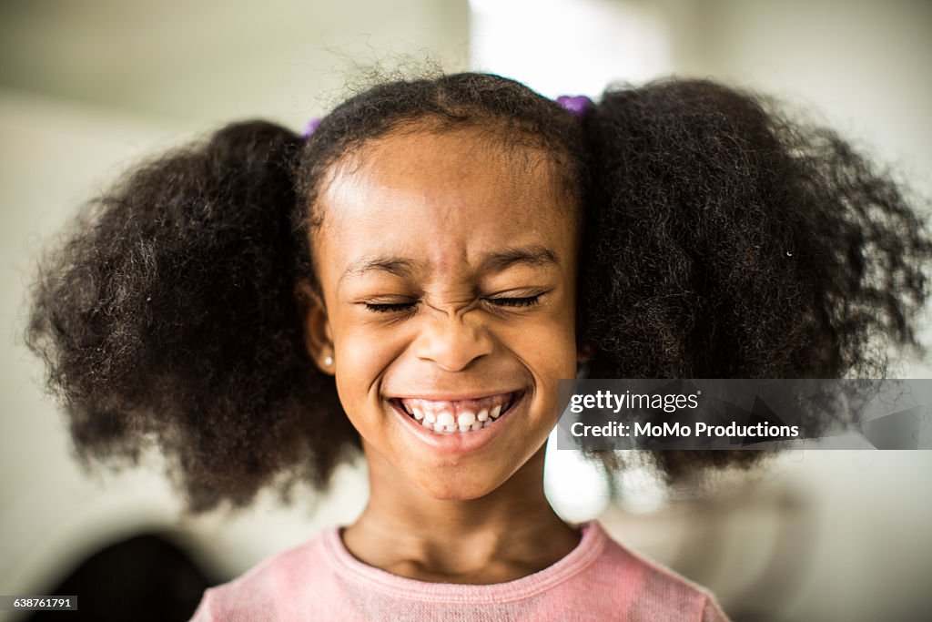 Girl (6yrs) with pigtails smiling