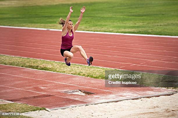 throwing everything she has at this jump - long jumper stock pictures, royalty-free photos & images