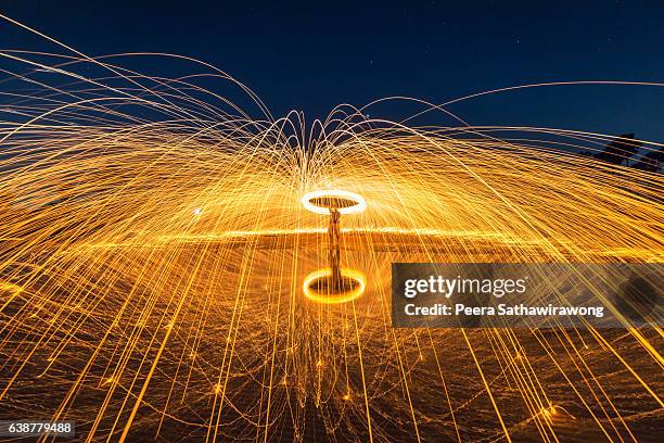 fire steel wool with water reflection - burning steel wool firework stock pictures, royalty-free photos & images