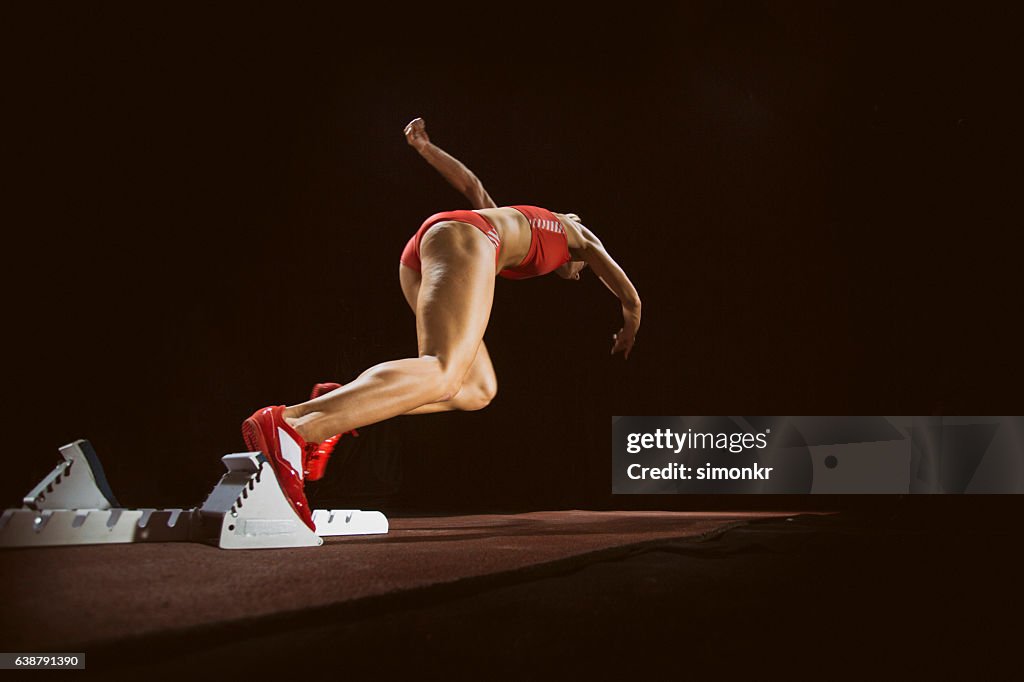 Female athlete running on track