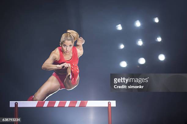 athlète franchissant l’obstacle - hurdling photos et images de collection