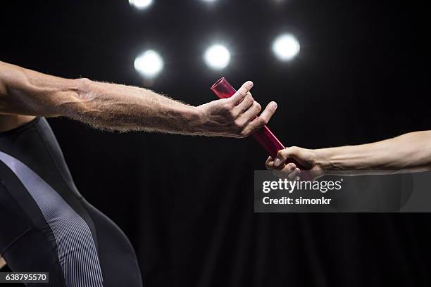 runners passing baton - challenge accepted stock pictures, royalty-free photos & images