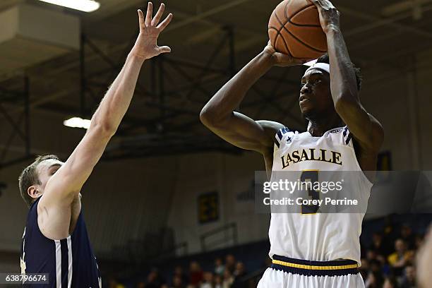 Cleon Roberts of the La Salle Explorers fires the last shot during the first half against Tyler Cavanaugh of the George Washington Colonials at Tom...