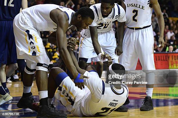 Tony Washington and B.J. Johnson help up Jordan Price, all of the La Salle Explorers, during the second half at Tom Gola Arena on January 15, 2017 in...