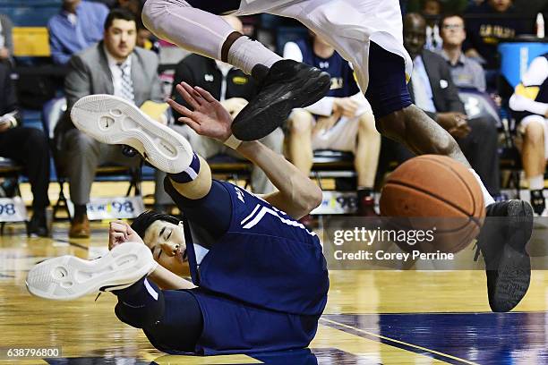 Yuta Watanabe of the George Washington Colonials fouls B.J. Johnson of the La Salle Explorers who leaps to avoid collision during the second half at...