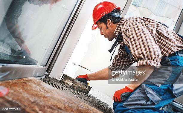 handyman laying ceramic tiles. - flooring installation stock pictures, royalty-free photos & images