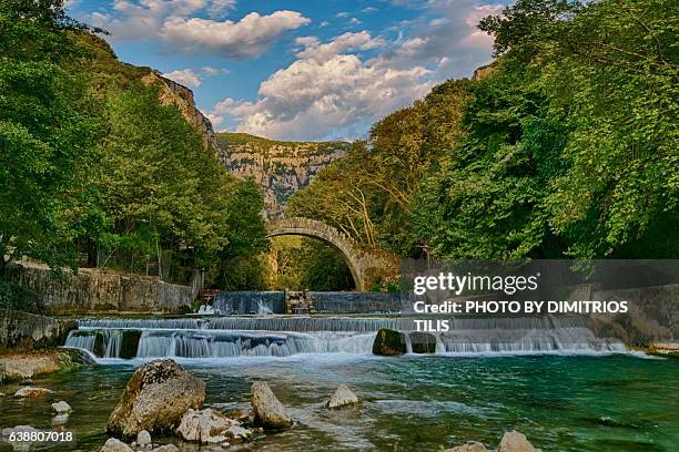 klidhonia's stone bridge & waterfalls - dimitrios tilis stockfoto's en -beelden