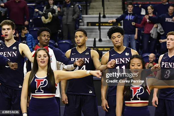 Max Rothschild, Shawn Simmons, Matt Howard, Tyler Hamilton and Jake Silpe, all of the Pennsylvania Quakers, perform the fight song as a tradition...