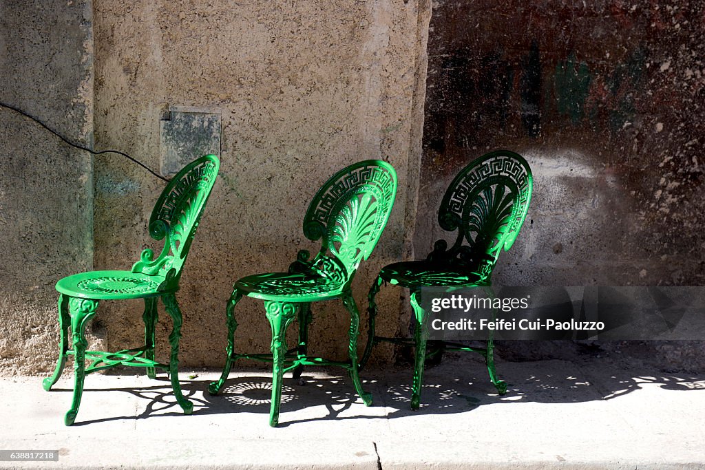 Three outdoor chairs at street of Vieja Havana in Cuba