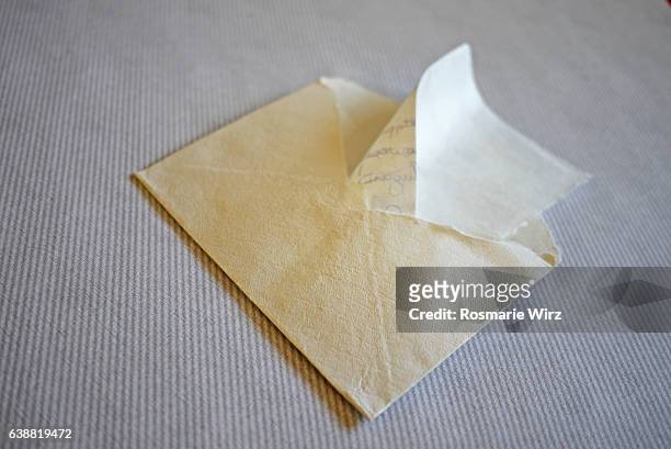 white envelope on striped grey background. - escritura a mano texto fotografías e imágenes de stock