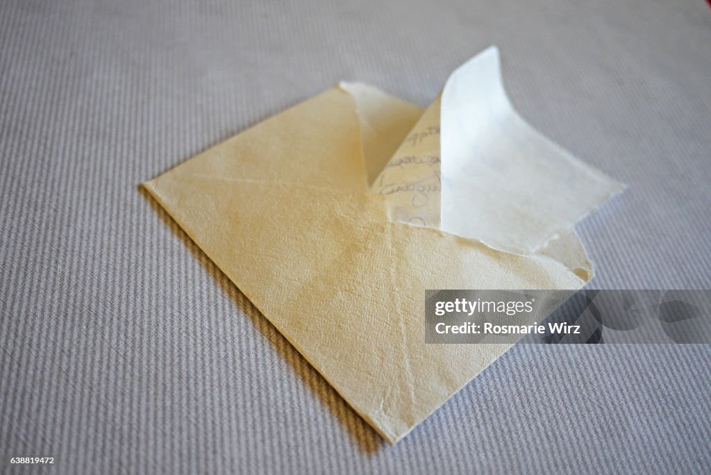 White envelope on striped grey background.