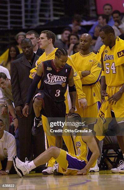 Allen Iverson of the Philadelphia 76ers steps over Tyronn Lue of the Los Angeles Lakers in game one of the NBA Finals at Staples Center in Los...