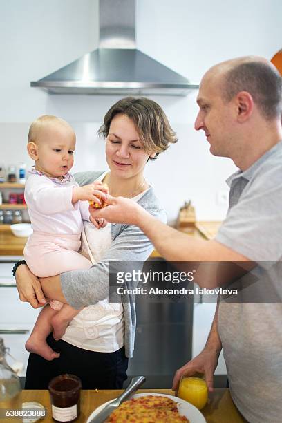 happy family cooking french breakfast together - alexandra iakovleva stockfoto's en -beelden