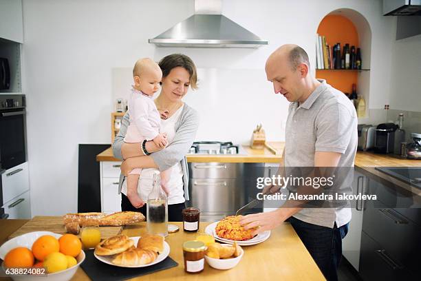 happy family cooking french breakfast together - alexandra iakovleva stockfoto's en -beelden