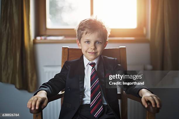 portrait of a cute little business man or politician - voorzitter stockfoto's en -beelden