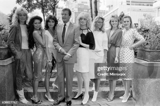 Roger Moore, star of the new James Bond film 'Octopussy' today met the press accompanied by the glamorous girls from the film. L-R Janine Andrews,...