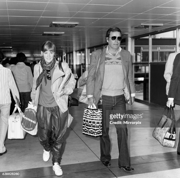 Robert Wagner and his 18-year-old daughter Katie at London Airport to fly to Los Angeles. 30th April 1982.