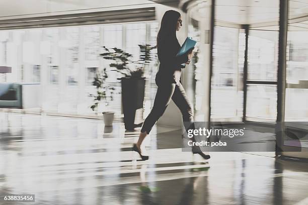 businesswoman walking in lobby - star style lounge imagens e fotografias de stock