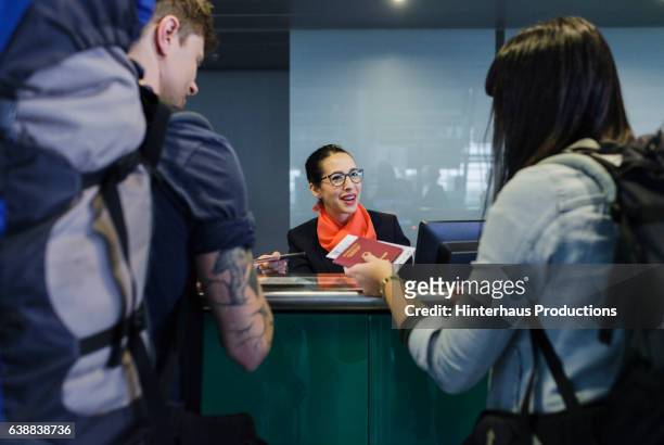 checking-in at airline counter - german passports stock-fotos und bilder