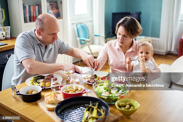 happy family eating lunch together at home - alexandra anka bildbanksfoton och bilder